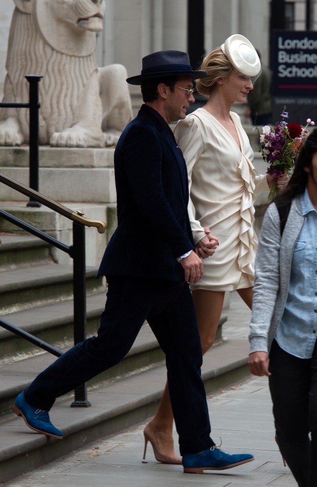 The pair emerged from the ceremony after an hour with their wedding bands proudly on display