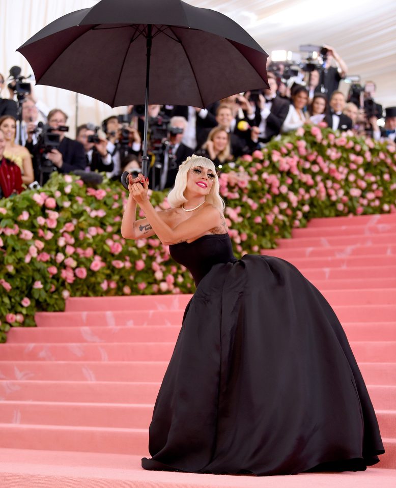  The next layer was a black dress which she teamed with an umbrella