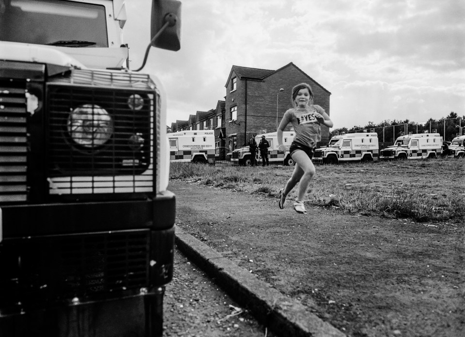  This young girl sprints alongside a defender as hoards of police cars line Stanhope Street, Carrick Hill