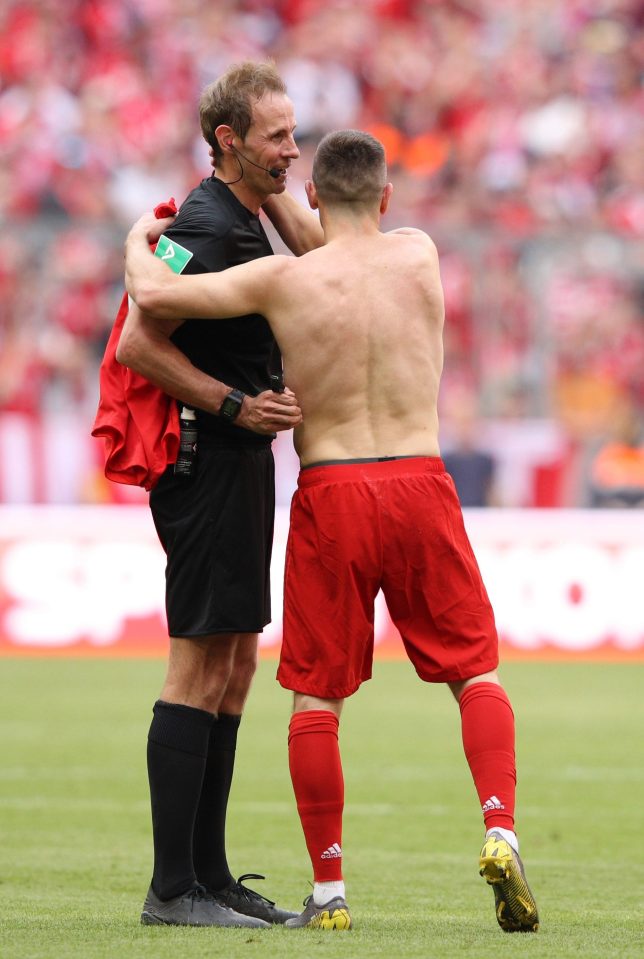  Ribery hugs the ref after being booked for taking off his shirt