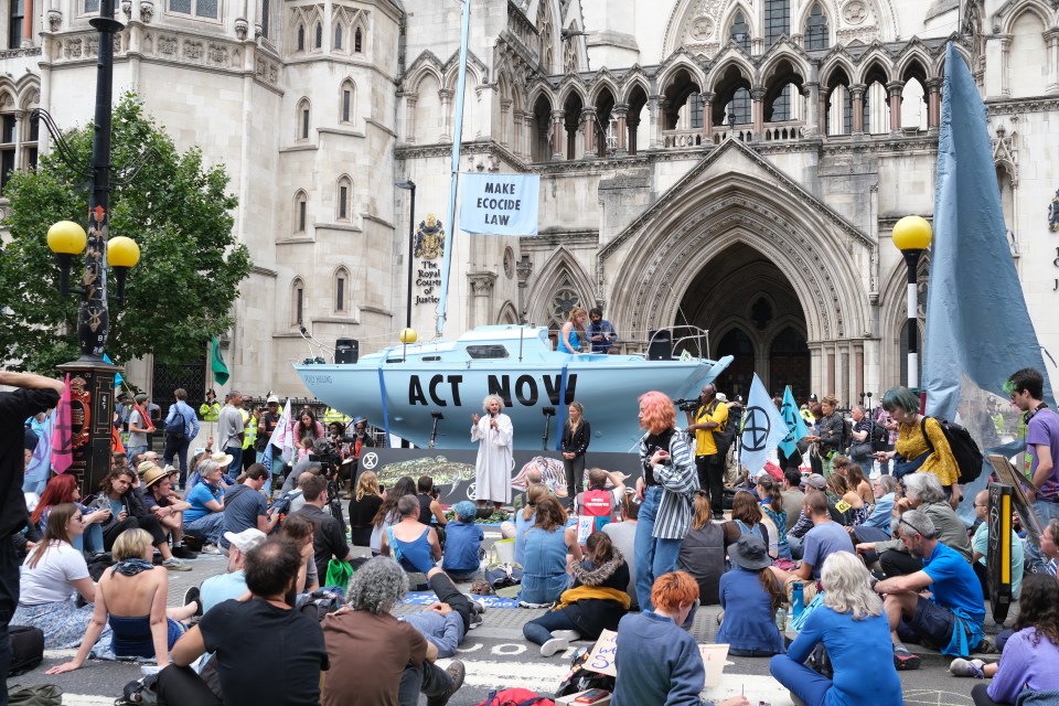 Extinction Rebellion block Fleet Street outside the Royal Courts of Justice as part of a new round of environmental protests, with their new blue boat