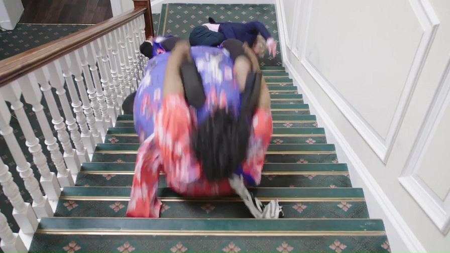  Her fellow 'fallers' pile-up at the bottom of the stairs