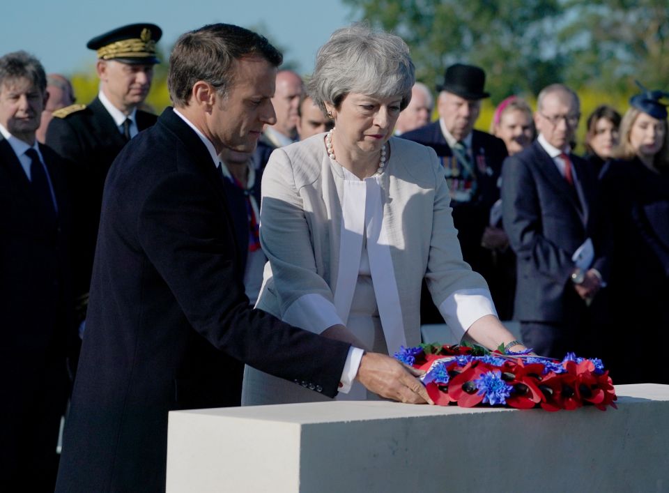  Macron and Theresa May laying wreaths to remember the war dead on the morning of D-Day, 75 years on