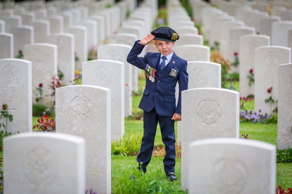  6-year-old George Sayer salutes the graves of soldiers