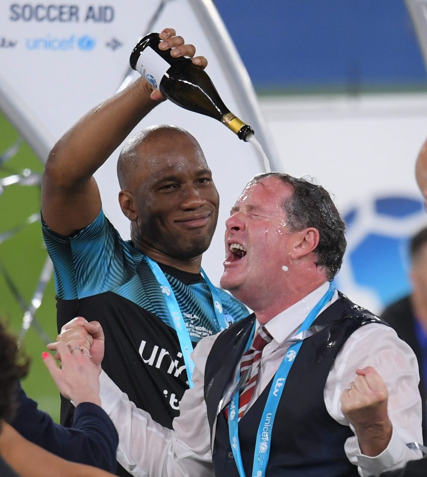 Didier Drogba empties a bottle of champers over Piers Morgan's head after the Soccer Aid for Unicef match at Stamford Bridge, London