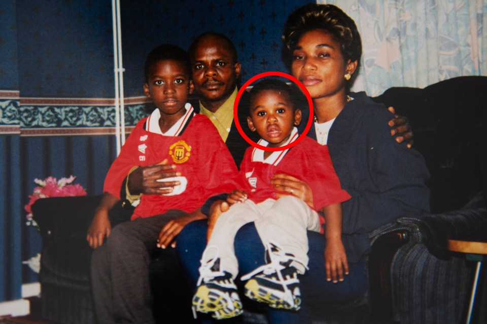  Aaron Wan-Bissaka sat with his mother wearing Man Utd shirt