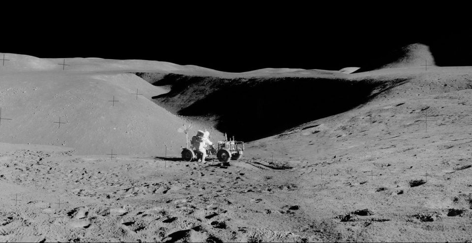  Panorama view of Apollo 15 lunar surface photos south of Station 2 taken by lunar module pilot James B. Irwin. Astronaut David R. Scott, mission commander, performs a task at the Lunar Roving Vehicle parked on the edge of Hadley Rille