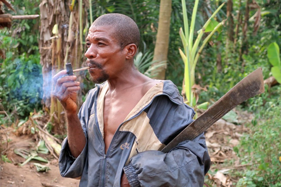  A member of the tribe is seen with his hunting knife while looking for monkeys
