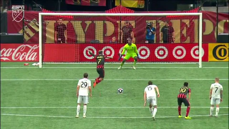 Martinez leaps into the air just before contact sending keeper Bill Hamid the wrong way