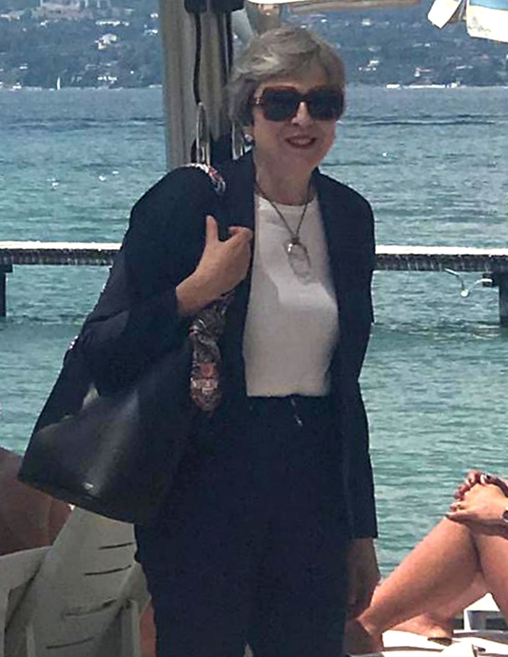  Theresa May looked relaxed at the start of her holiday in Italy