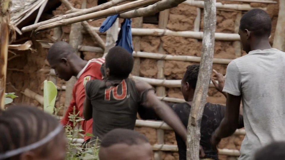  One man can be seen dragging his rival away into the jungle over a family drug debt