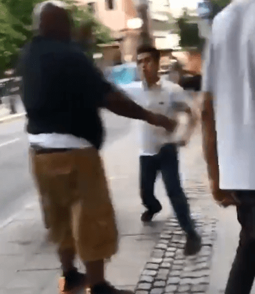 One of the men is seen smashing his headphones over the minder's head