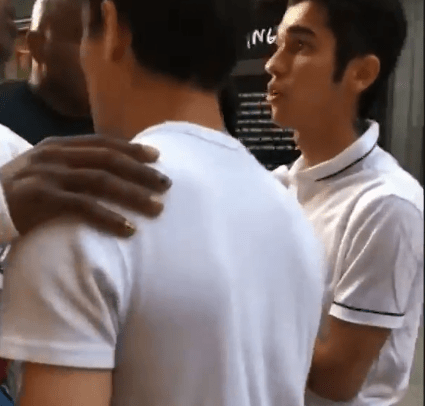 At one stage the rapper put his hand on the shoulder of one of the men in a bid to calm things down