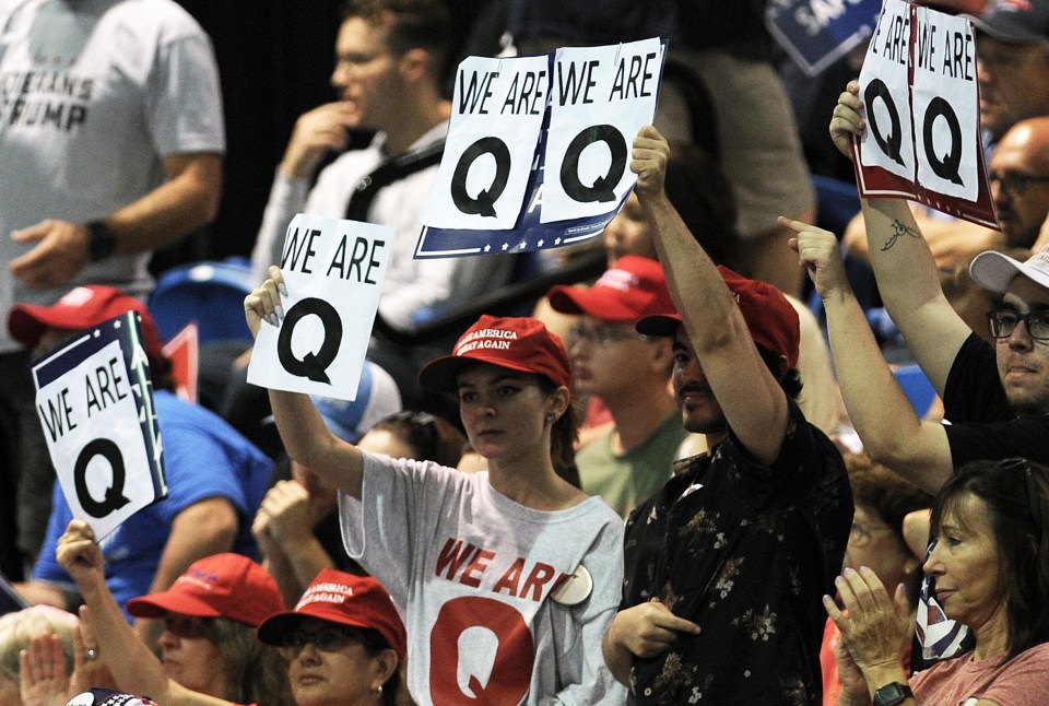 Donald Trump supporters at one of his rally are seen holding signs reading 'We are Q'