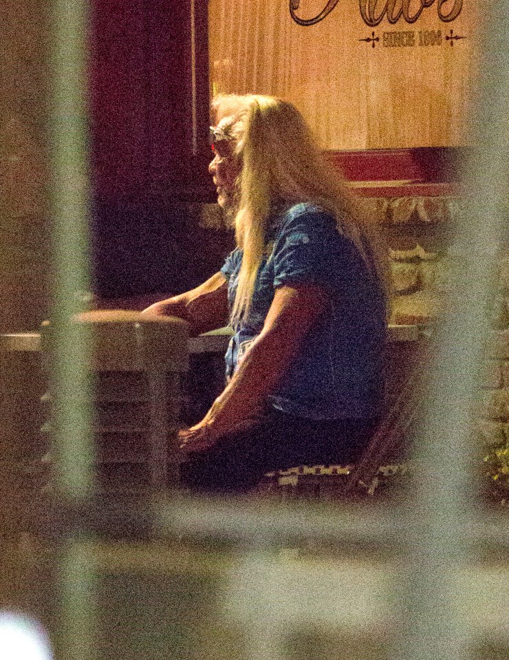 Duane wore a short-sleeve button-down shirt and kept his hair styled in his blonde signature mullet