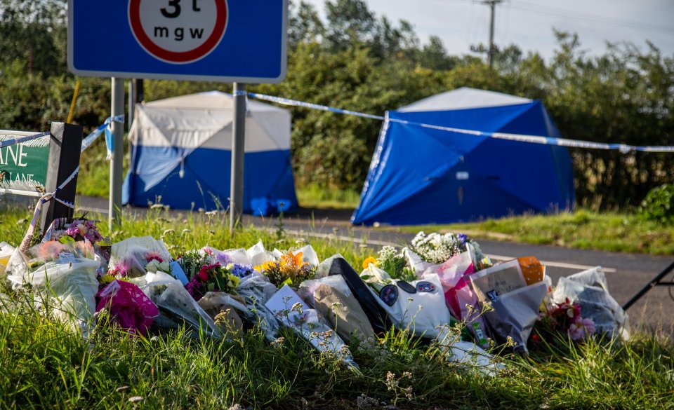  Floral tributes lined the road in Sulhamstead, Berks., where PC Harper lost his life