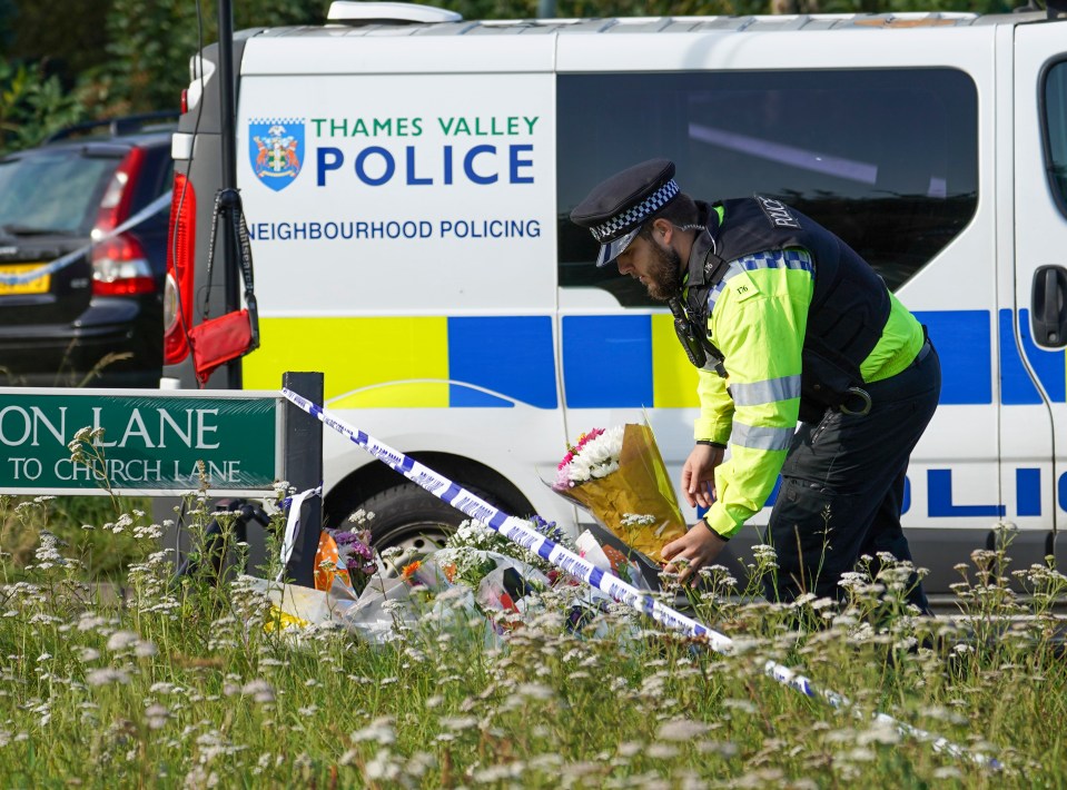  An officer pays his respects at the scene of the tragedy