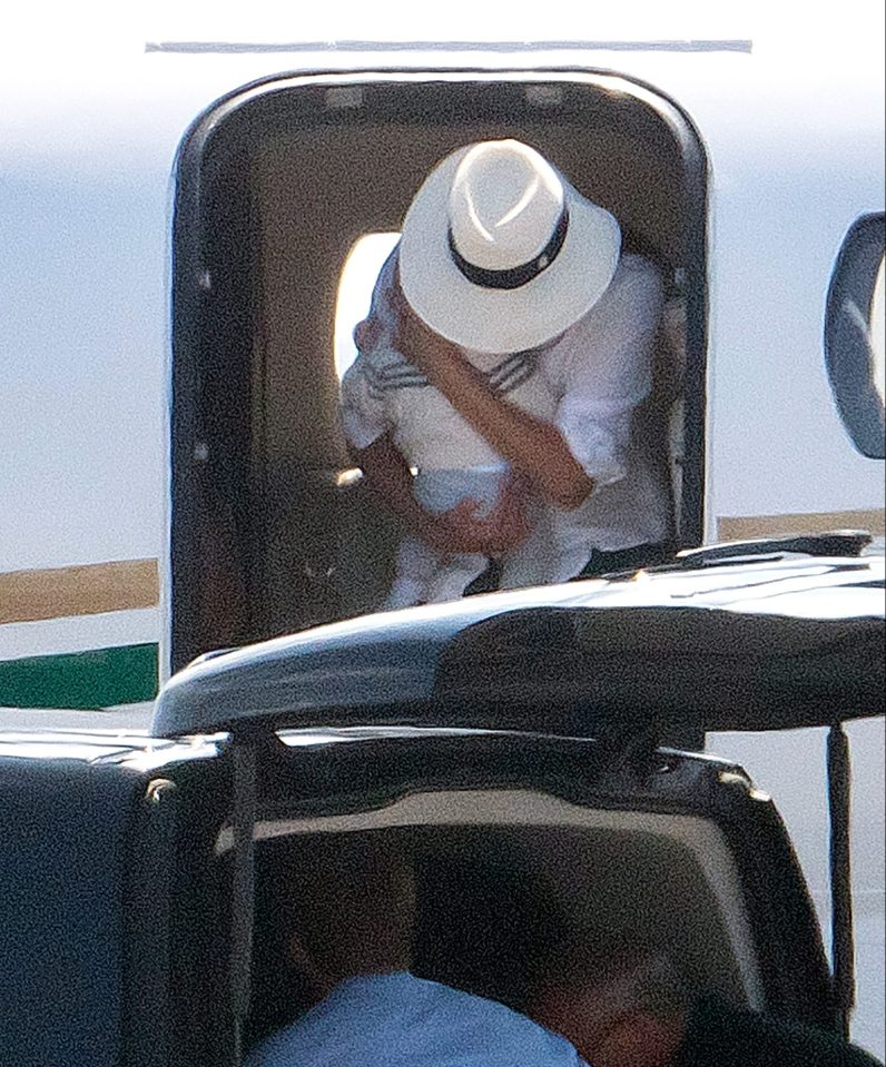 The Duchess of Sussex leaves the private jet holding her royal baby in a protective embrace
