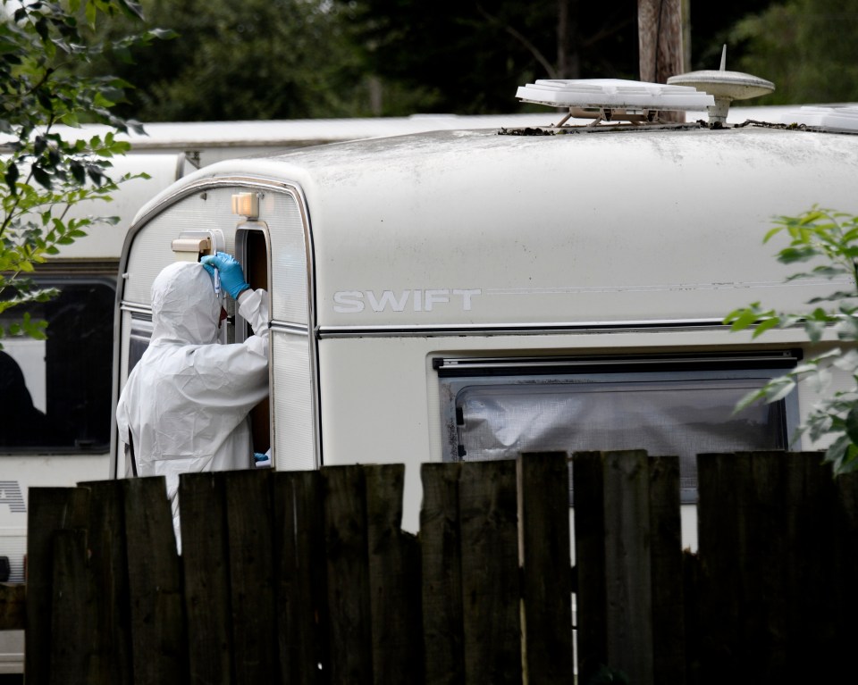  Forensics are seen at a caravan park at Burfield Common in Berkshire