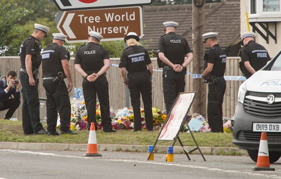 A group of mourning officers could be seen gathered around floral tributes reading messages to their fallen colleague.