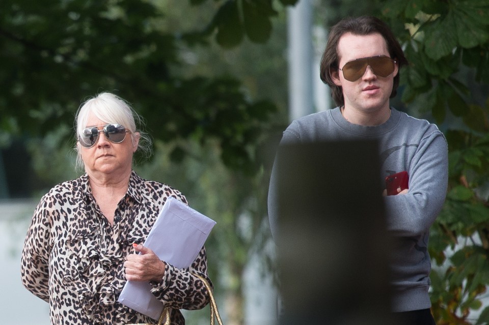 a man and a woman wearing sunglasses are standing next to each other