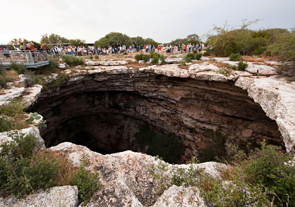 People watch bats fly from the Devil's Sinkhole in Texas.