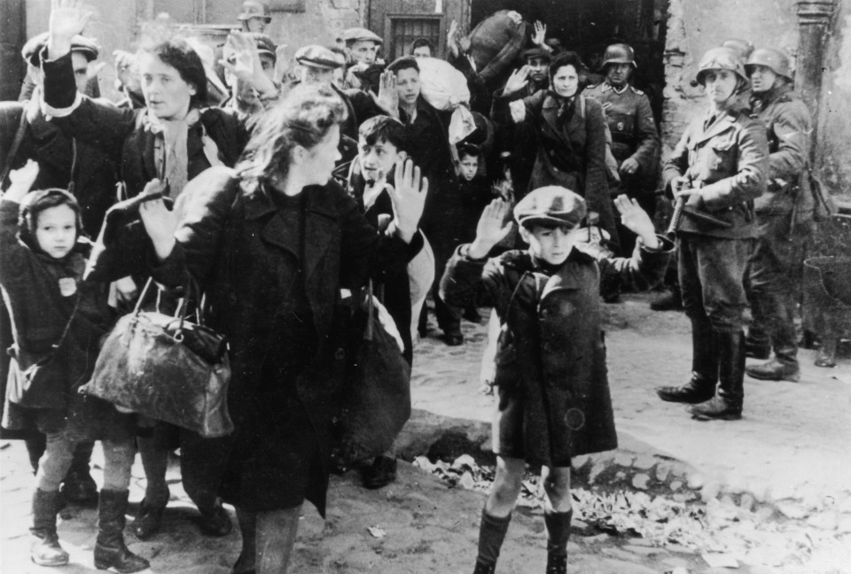 Jews from the Warsaw Ghetto surrender to German soldiers after a failed uprising 