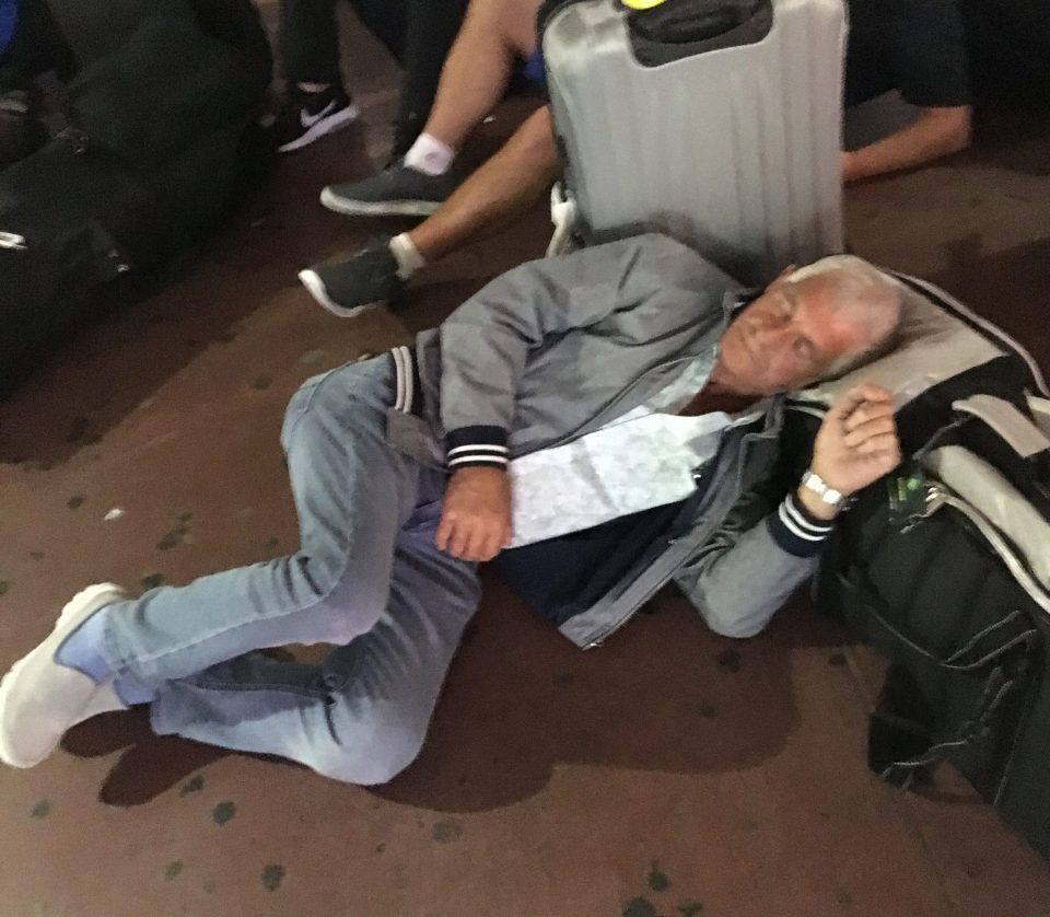 A holidaymaker lays on the ground as his Thomas Cook plane broke down in Turkey, leaving him stranded