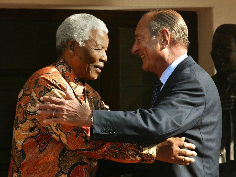 Chirac hugs Nelson Mandela after their meeting in Johannesburg in 2002