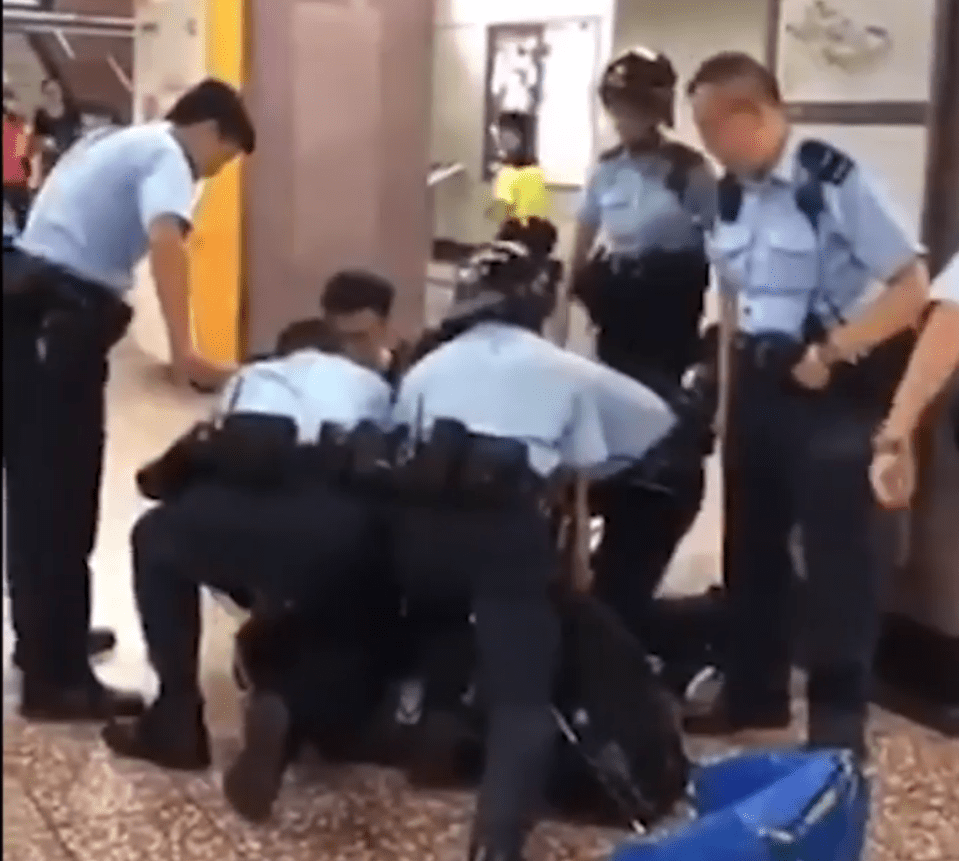  A man loses consciousness at a train station in Hong Kong while being arrested by cops
