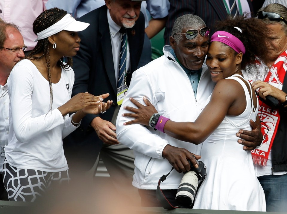  Serena hugs her father as sister Venus looks on at Wimbledon in 2012