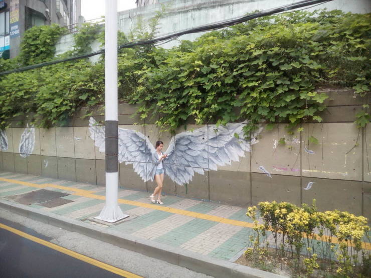  Perfectly timed snap shows huge wings sprouting from woman's back