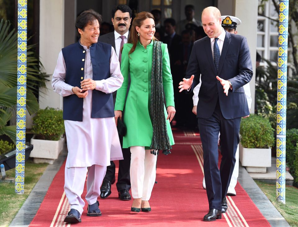 The Duke and Duchess of Cambridge walk alongside the Prime Minister of Pakistan Imran Khan after having lunch at his official residence