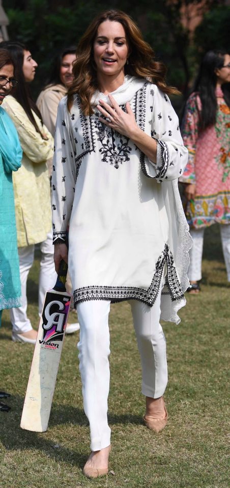 Kate wore an embroidered white tunic and trousers for the visit