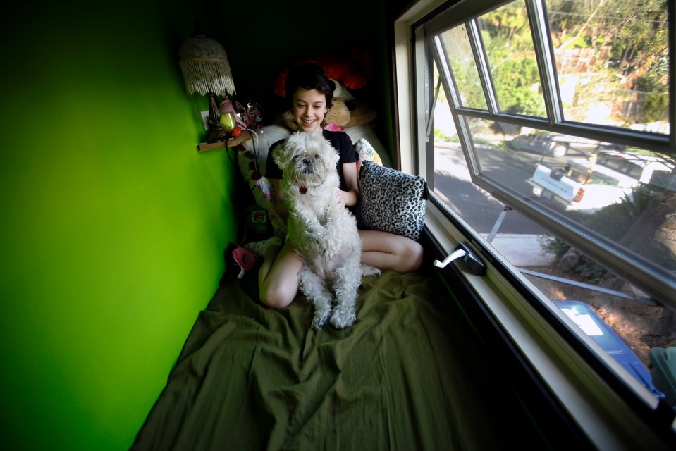  In Los Angeles, US, Jay Segal plays with her dog 'Bubbers' in a little loft her father, Todd Segal, built into their 625-sq-ft home