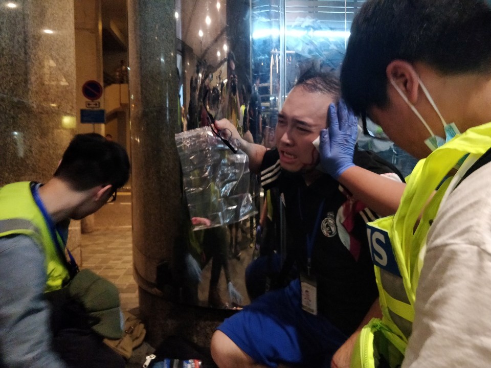  Andew Chiu receives help from first aiders after being injured in a knife attack at a shopping centre