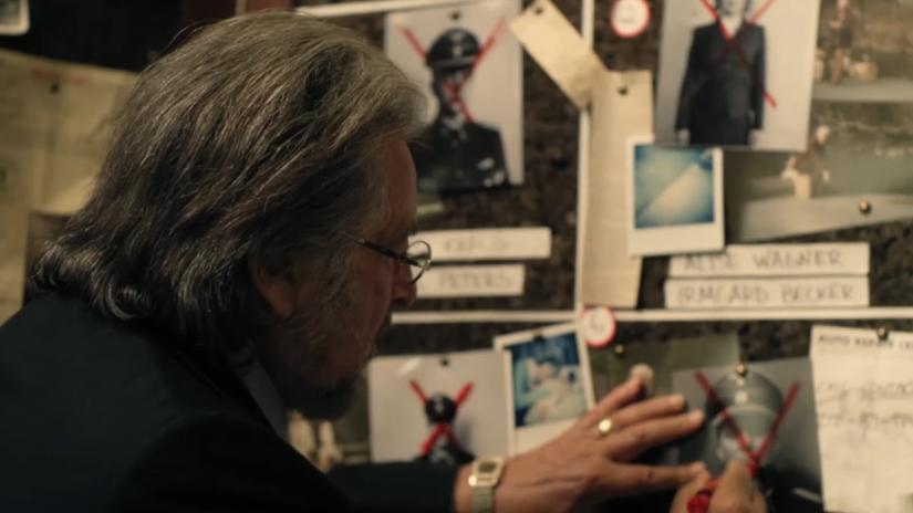  He is seen drawing an 'X' through a picture of a Nazi in the teaser