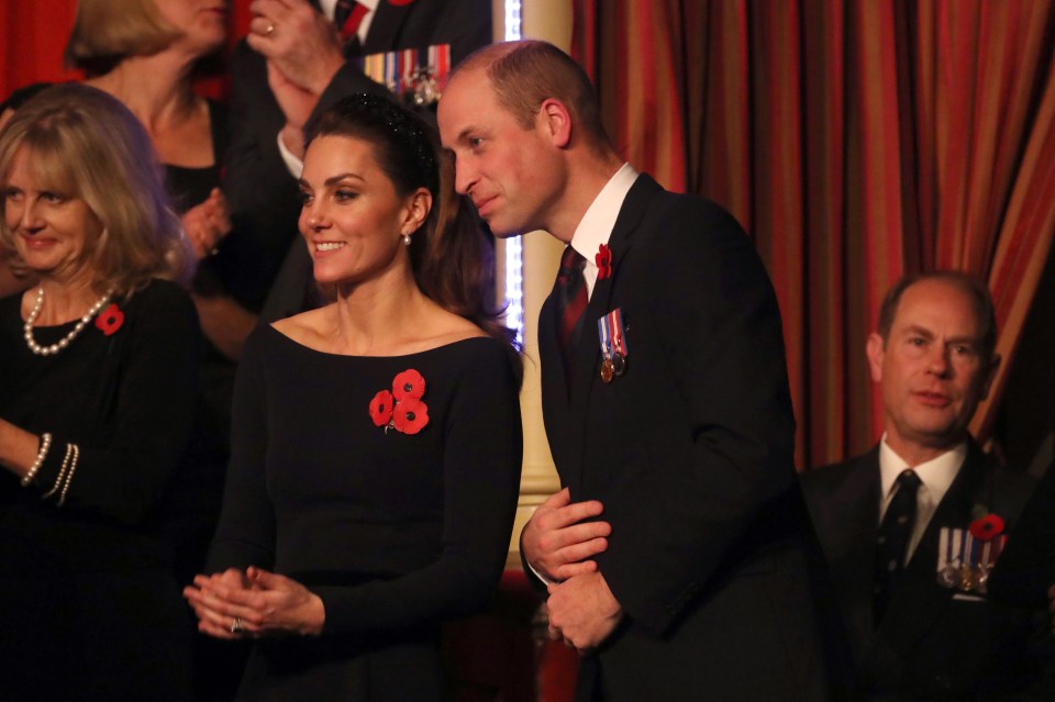  William was seen leaning over to Kate as they both smiled