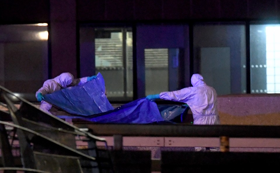 Police forensic officers work where a man was killed on London Bridge today