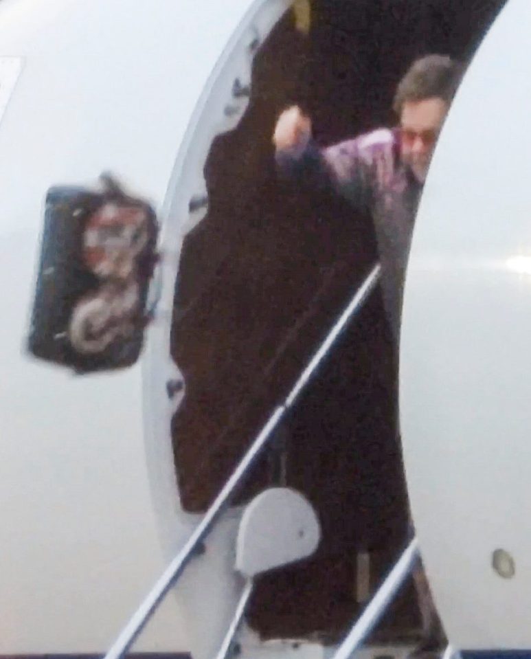 Elton John was snapped flinging his Gucci bag out of his private jet