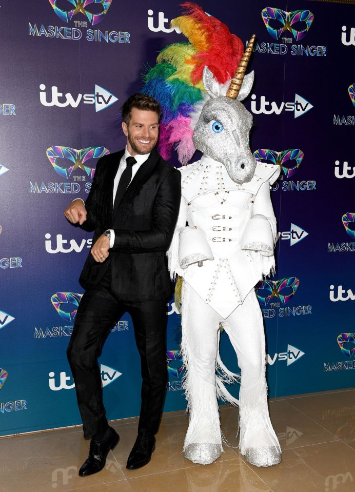 Host Joel Dommett prances around with Unicorn on The Masked Singer