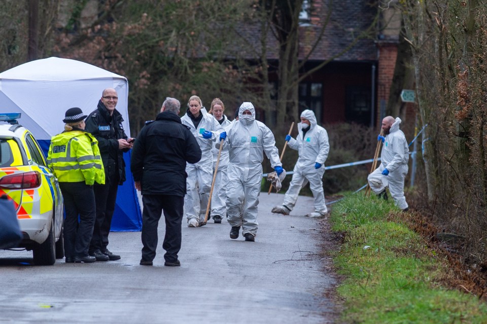  Forensic officers scour the scene next to an airfield in Elstree, Herts, after a body was found