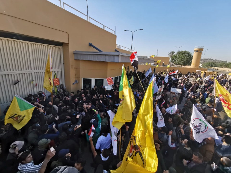 Pro-Iran protesters smash down gates and storm US embassy in Iraq
