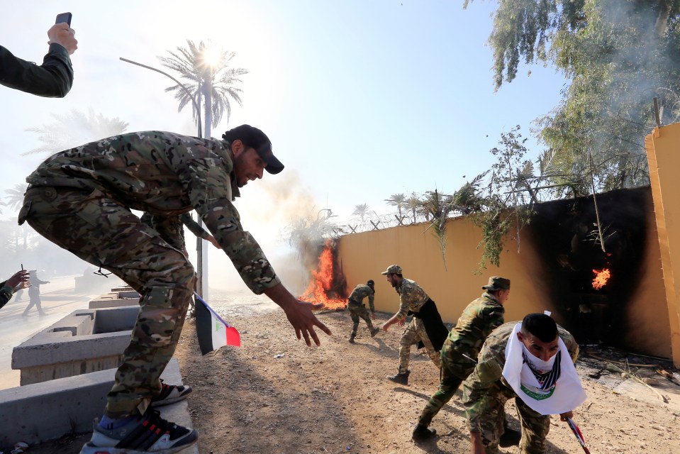 Pro-Iran protesters smash down gates and storm US embassy in Iraq