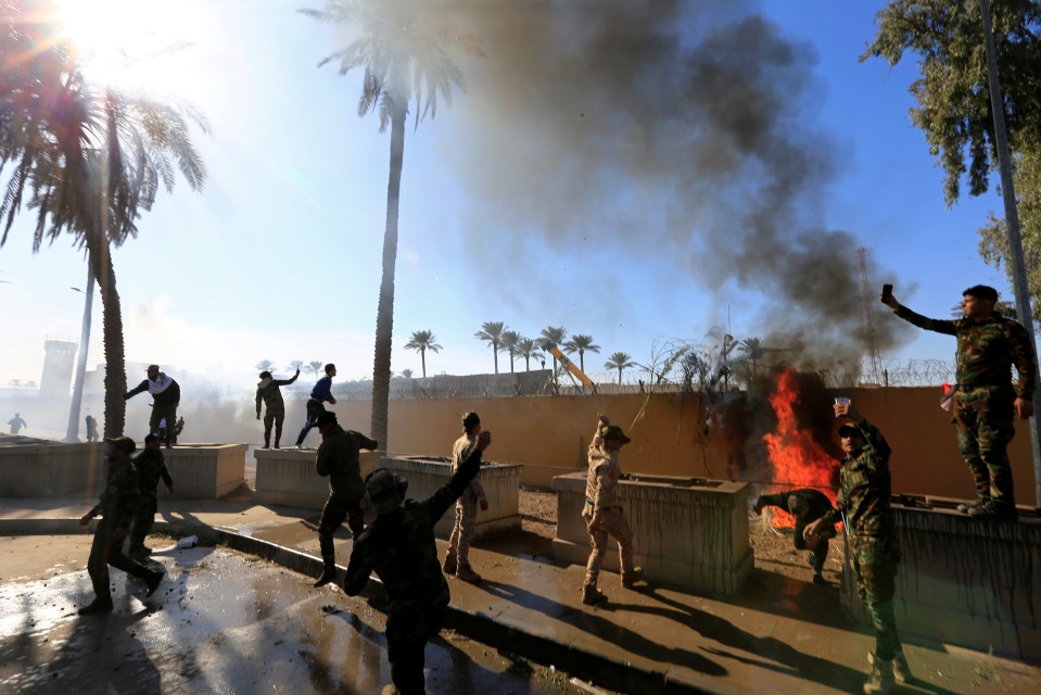 Pro-Iran protesters smash down gates and storm US embassy in Iraq