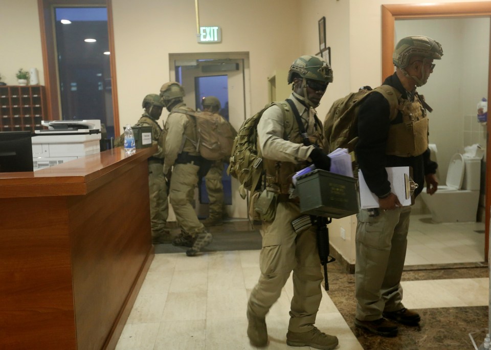 US soldiers seen inside the embassy ready to take on the rioters if they got further into the compound