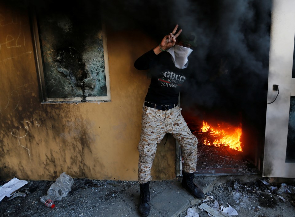 A member of the Hashd al-Shaabi paramilitary forces wearing a Gucci top poses in the US embassy