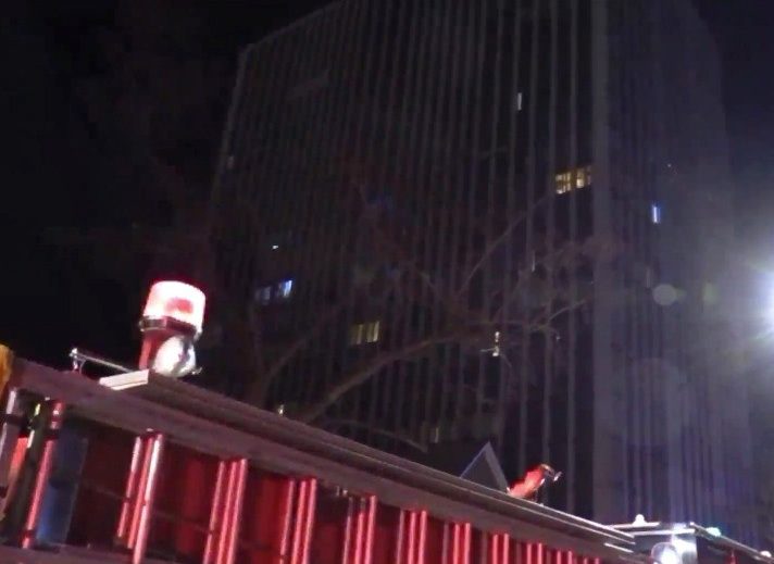 Cops said they found her in front of the high-rise tower lying beside her motionless toddler