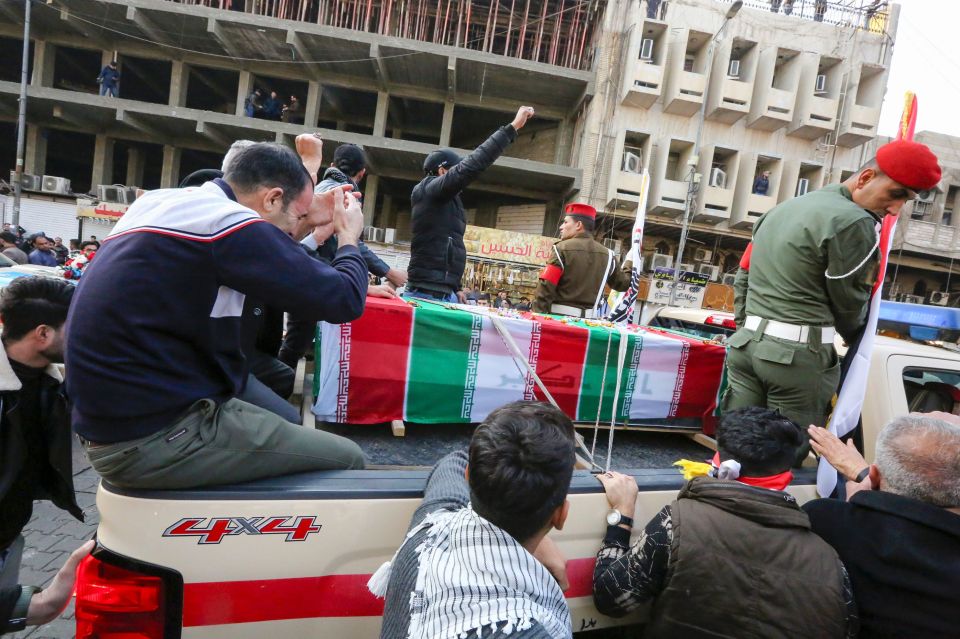 Mourners marched in the streets alongside militia vehicles during the procession
