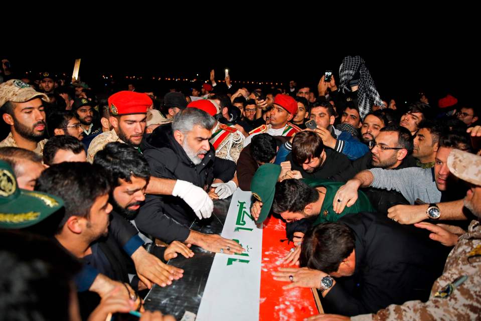 Locals carry the casket of Iranian commander Qasem Soleimani upon arrival at Ahvaz International Airport